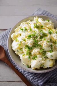 Bowl of easy creamy potato salad with herbs and spices