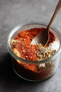 Homemade fajita seasoning mix ingredients and final product in a bowl