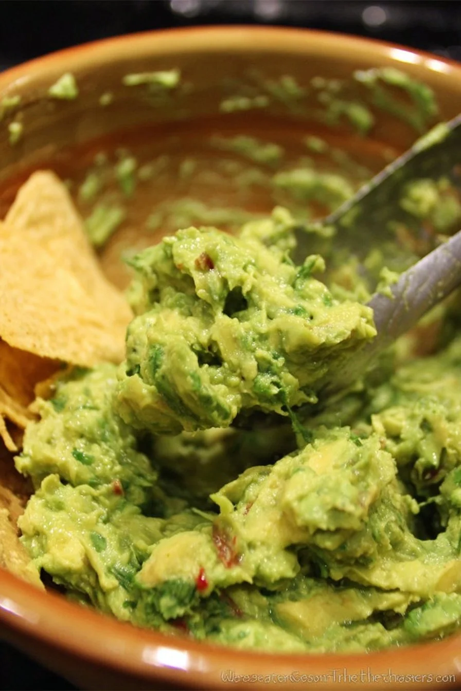 Bowl of fresh Chipotle guacamole with lime and cilantro