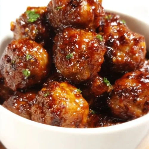 Oven baked honey garlic meatballs on a serving plate