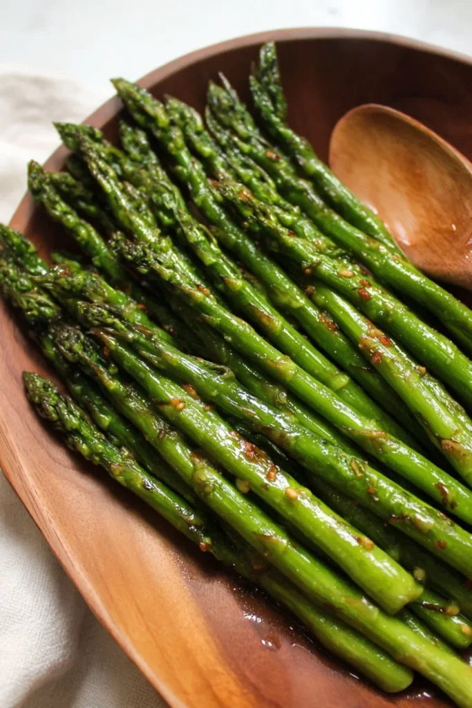 A plate of delicious oven-roasted asparagus garnished with seasoning.
