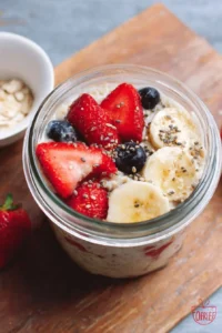 Bowl of overnight oatmeal topped with fruits and nuts