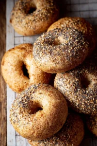 Whole wheat sourdough bagels fresh out of the oven, golden and chewy.