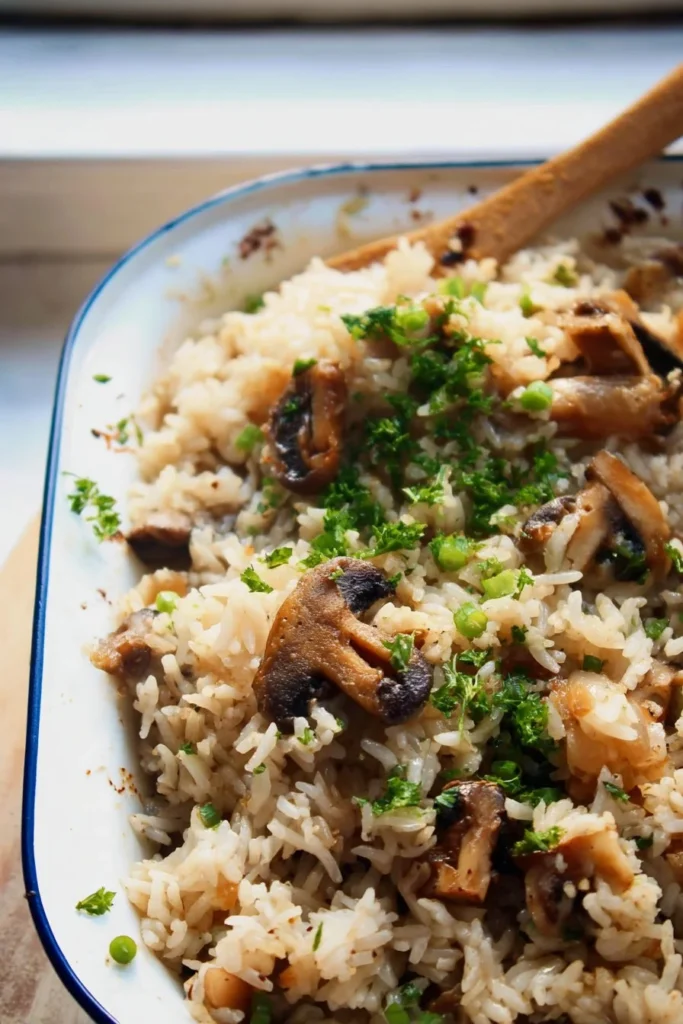 Baked Mushroom Rice garnished with fresh herbs in a serving dish