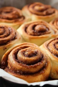 Freshly baked bread machine cinnamon rolls topped with icing