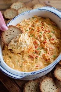Delicious Cajun Crab Dip served in a bowl with chips and herbs
