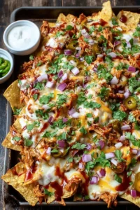 Easy sheet pan BBQ chicken nachos topped with cheese and jalapenos
