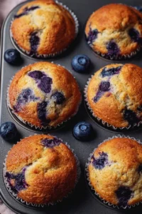 Freshly baked hearty blueberry protein muffins on a cooling rack