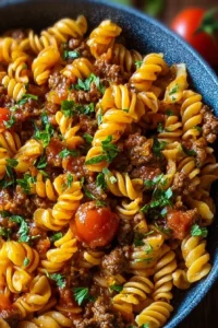 One Pot Beef Taco Pasta in a skillet, showcasing a colorful mix of ingredients.