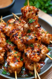 Delicious Bang Bang Chicken Skewers served on a platter, garnished and ready to eat.