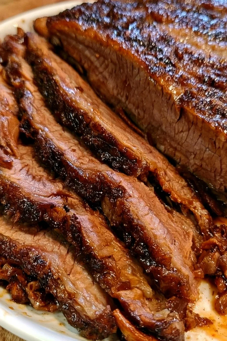 Oven-cooked beef brisket served with sides in a rustic setting