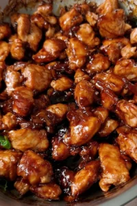 Plate of bourbon chicken served with rice and vegetables