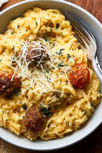 Creamy Cheesy Orzo Pasta served in a bowl with fresh herbs