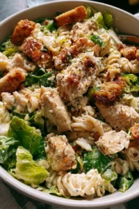 Delicious Chicken Caesar Pasta Salad served in a bowl with fresh ingredients