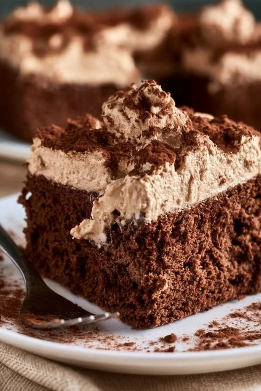 Delicious Chocolate Three Milks Cake topped with whipped cream and chocolate shavings