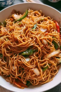 Plate of classic Chinese stir-fried noodles with vegetables and protein