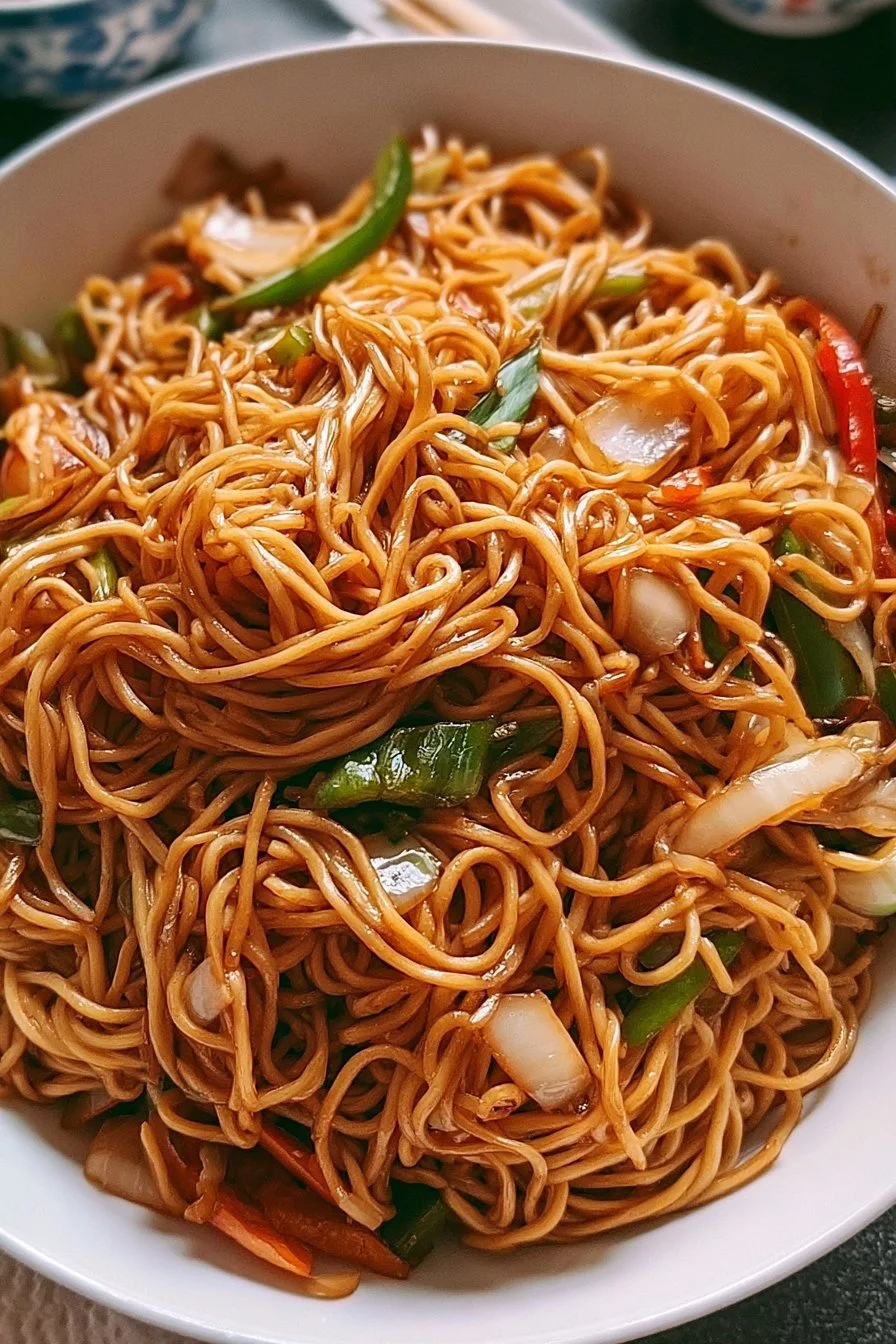 Plate of classic Chinese stir-fried noodles with vegetables and protein