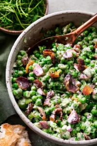 Creamy pea salad with bacon served in a bowl