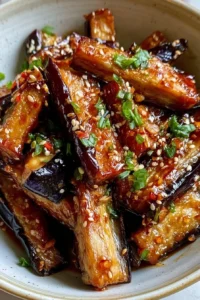 Crispy eggplant in garlic soy glaze served on a plate