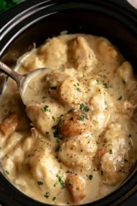 Chicken pieces in creamy sauce inside a slow cooker