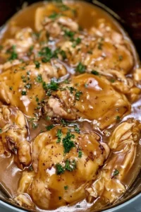 Crockpot chicken thighs in savory gravy served with vegetables