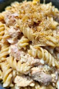 Crockpot Garlic Parmesan Chicken Pasta served in a bowl with herbs on top