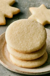 Plate of easy sugar cookies decorated with icing and sprinkles