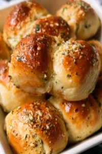 Freshly baked garlic bread rolls with herbs and butter