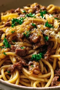 Delicious Garlic Butter Beef Pasta served in a bowl topped with herbs