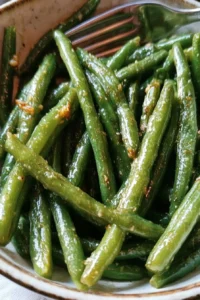 Garlic butter sautéed green beans served as a side dish