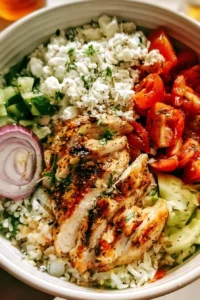 Delicious Greek Chicken Bowl with fresh vegetables and herbs