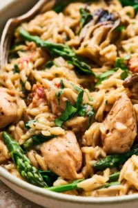 High protein chicken orzo dish with fresh ingredients and vibrant colors