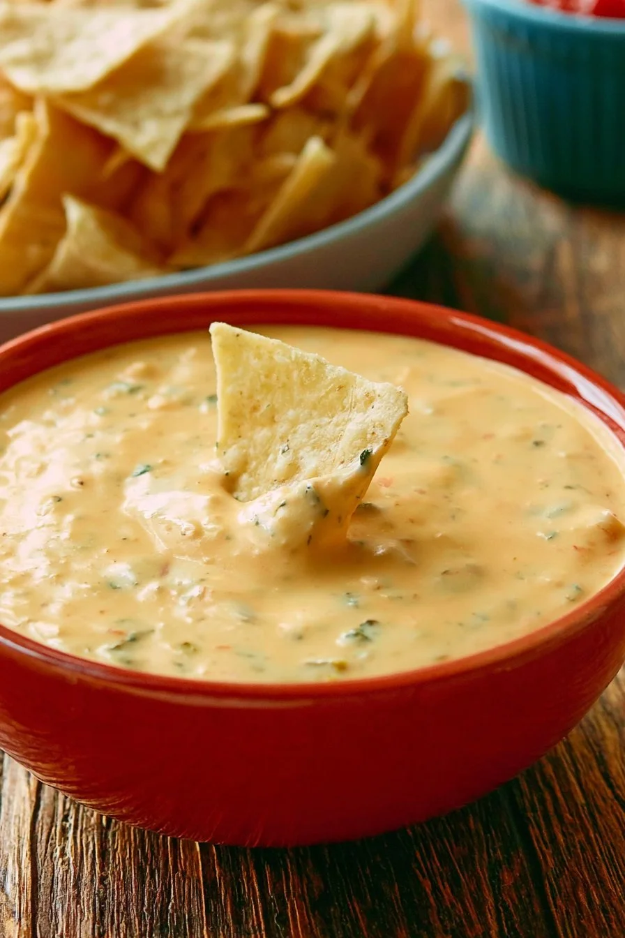 Homemade queso dip served in a bowl with tortilla chips