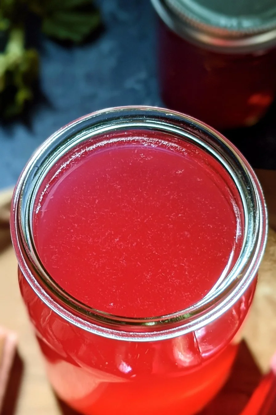 Home 29 A bottle of homemade rhubarb syrup ready to enhance beverages and desserts.