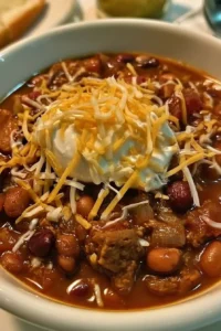 Bowl of Jamie Deen's award-winning chili recipe topped with fresh herbs