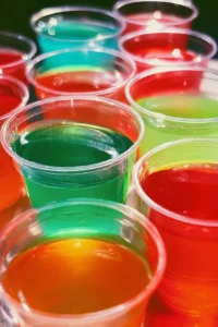 Colorful jello shots in clear cups, perfect for parties and celebrations.