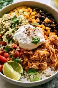 Mexican-inspired slow cooker chicken bowl with rice and toppings
