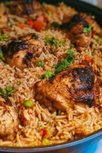 One Pot Chicken and Rice dish served in a skillet, garnished with herbs.
