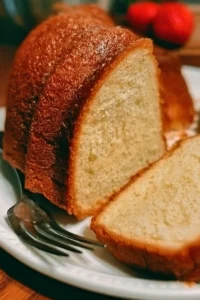 Slice of perfect pound cake on a plate with berries