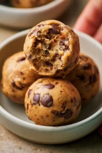 Delicious protein-packed no-bake cookie dough balls on a plate