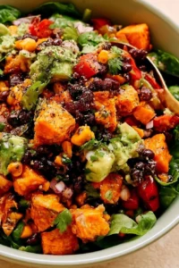 Roasted sweet potato black bean salad in a bowl with toppings