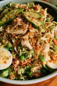 Delicious rotisserie chicken salad in a bowl with fresh vegetables