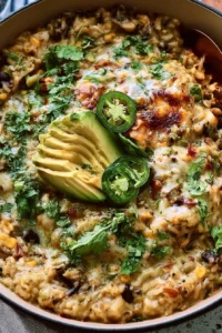 Salsa Verde Chicken and Rice Skillet topped with fresh herbs and served in a skillet