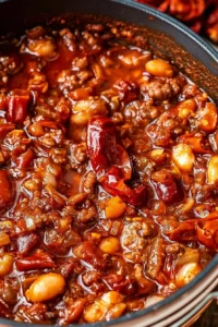 Delicious bowl of smoked chili garnished with fresh herbs and spices