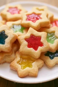 Colorful stained glass cookies decorated and displayed on a plate.