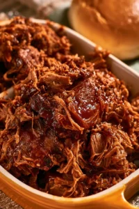 Delicious Texas Cola Shredded Beef Brisket served on a plate with side dishes