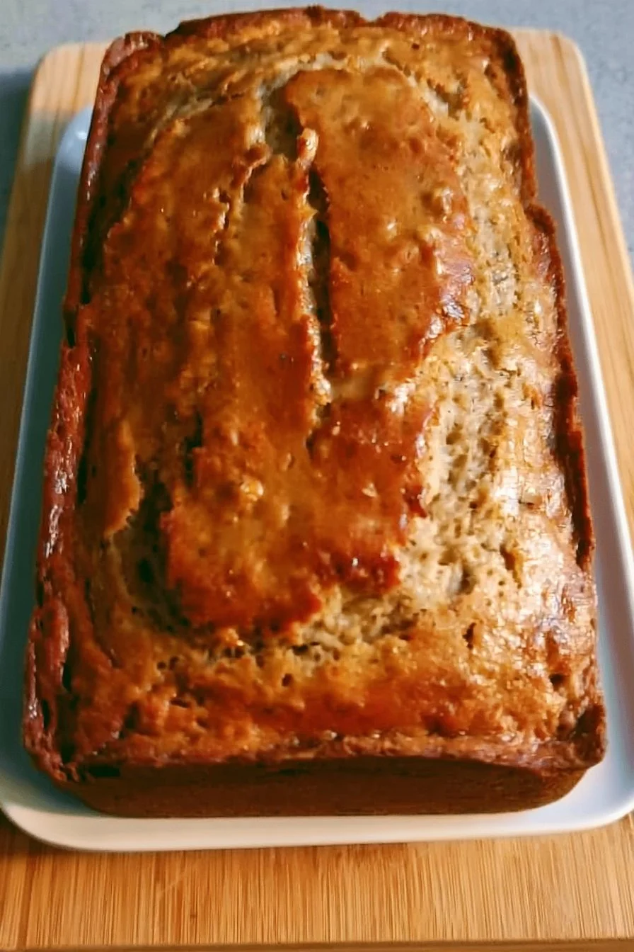 Delicious slice of the best banana bread on a wooden table